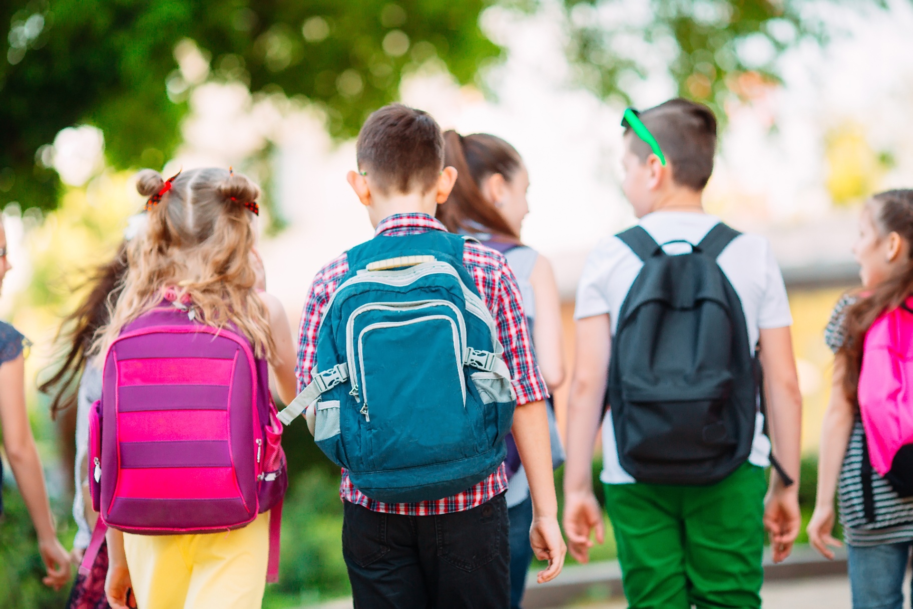 Kids walking to school with backpacks.